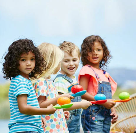 Kids playing pass the egg in spring