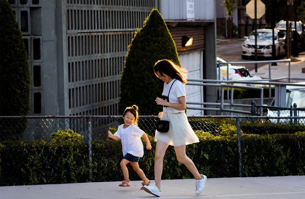 A lady and her daughter jogging to stretch their legs during a car journey